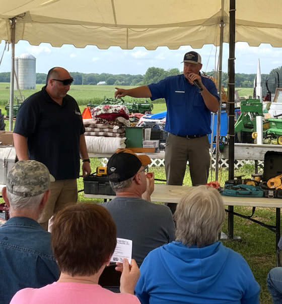 Auctioneer in front of a large group. Personal and Real Estate Property Auctions, Tennessee. Wally Gilliam Realty & Auction, Portland, TN