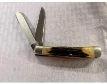 Pocket knife with two stainless steel blades extended and bone‑style handle on fabric surface.