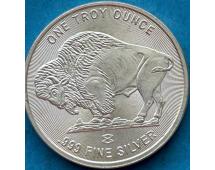 Silver coin with buffalo engraving and text reading One Troy Ounce .999 Fine Silver.