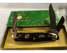 Pocket knife with three blades extended in green box labeled Frost Family Brand Pocket Knives.