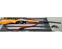 Rifle with wooden stock and leather sling on American flag surface with handgun and bullets.