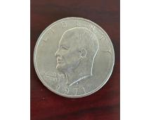 1974 Eisenhower dollar coin with Liberty text and Eisenhower profile on dark wooden surface.